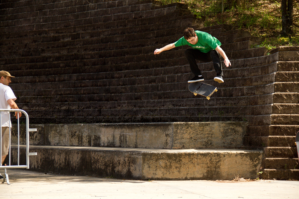 Troy Cobucci with a proper warmup kickflip while Bucky observes...