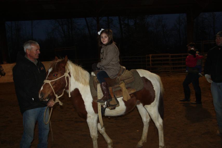 Brennie riding the pony by herself.