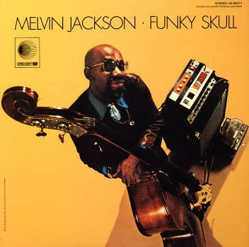 Melvin Jackson – Funky Skull Picture 8000 televisions facing inward as an igloo and you’re inside of it and they’re all playing Sanford and Son. Whoa what the heck how did I get in here and why is half of Art Ensemble of Chicago here? Melvin runs his bass through about twenty pedals and the result is the sound of a really cool duck being stepped on but the ducks on acid. No joke this is absolutely superb soul-jazz that gets out and then comes back hard, gets out again, then makes you dance. You can smoke weed and have a freaky little brunch to it with your mom. 