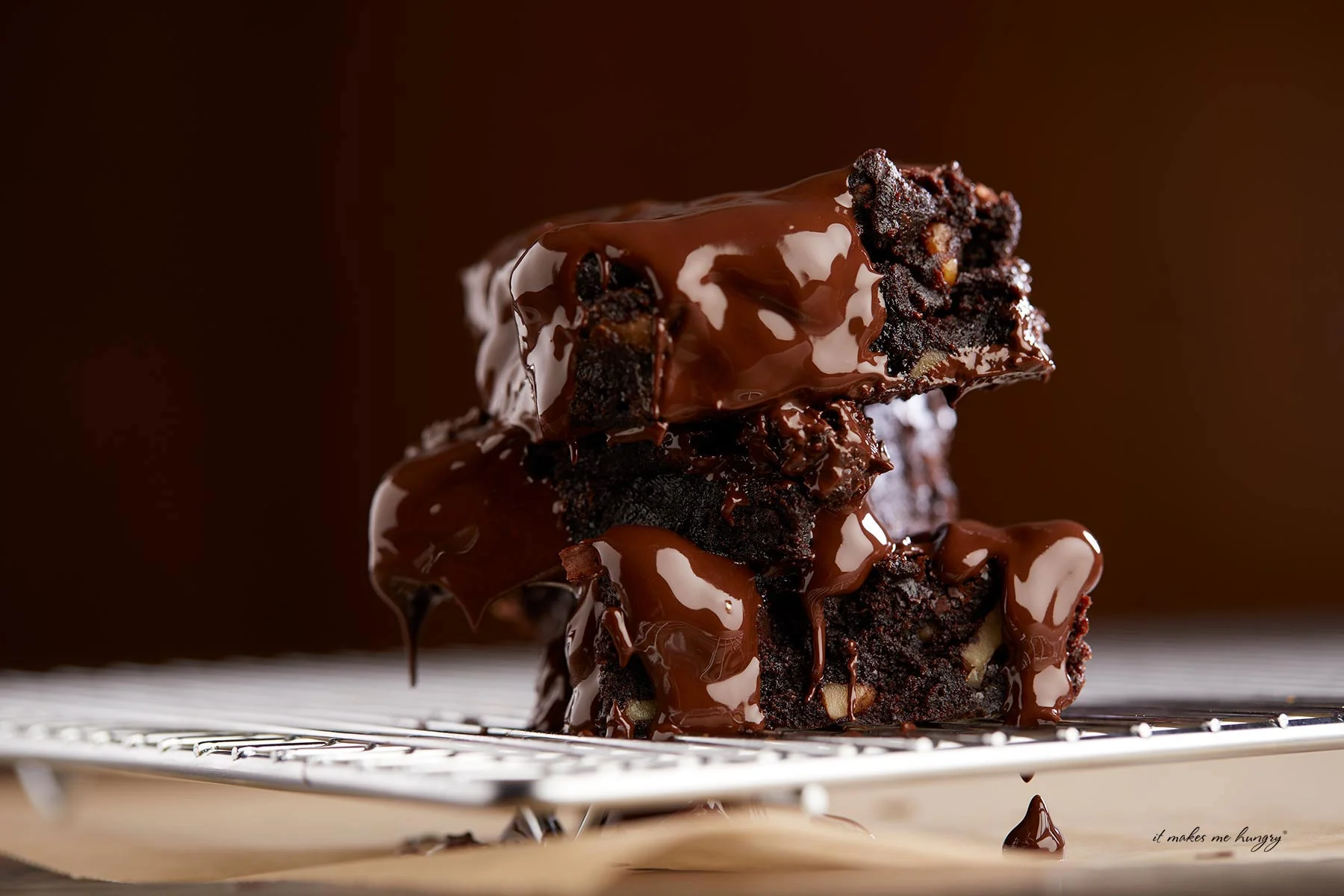 Stacked brownies with liquid chocolate over top