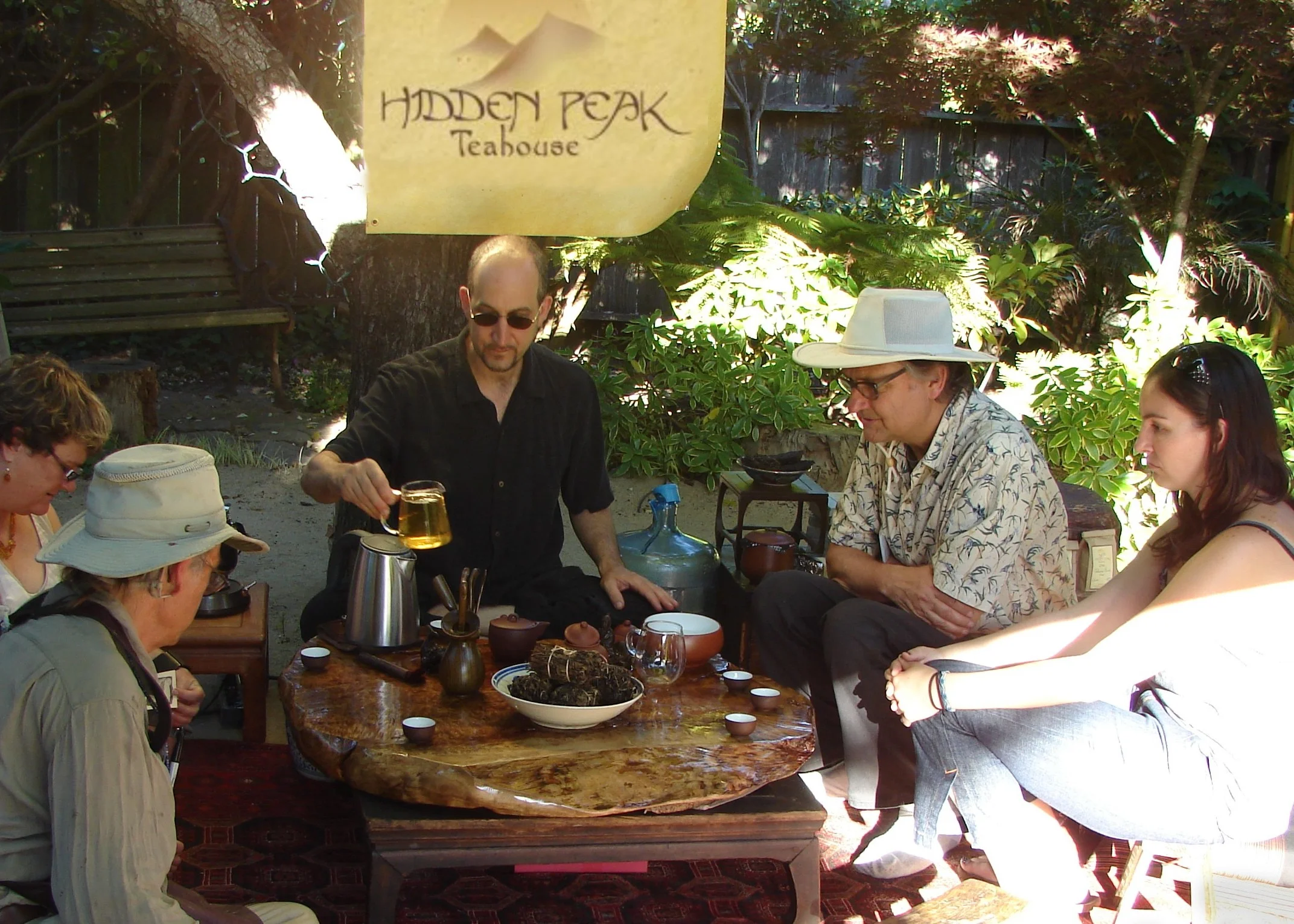 David Wright pouring tea at the 2012 Avant Garden Party as a fundraiser for New Music Works . 