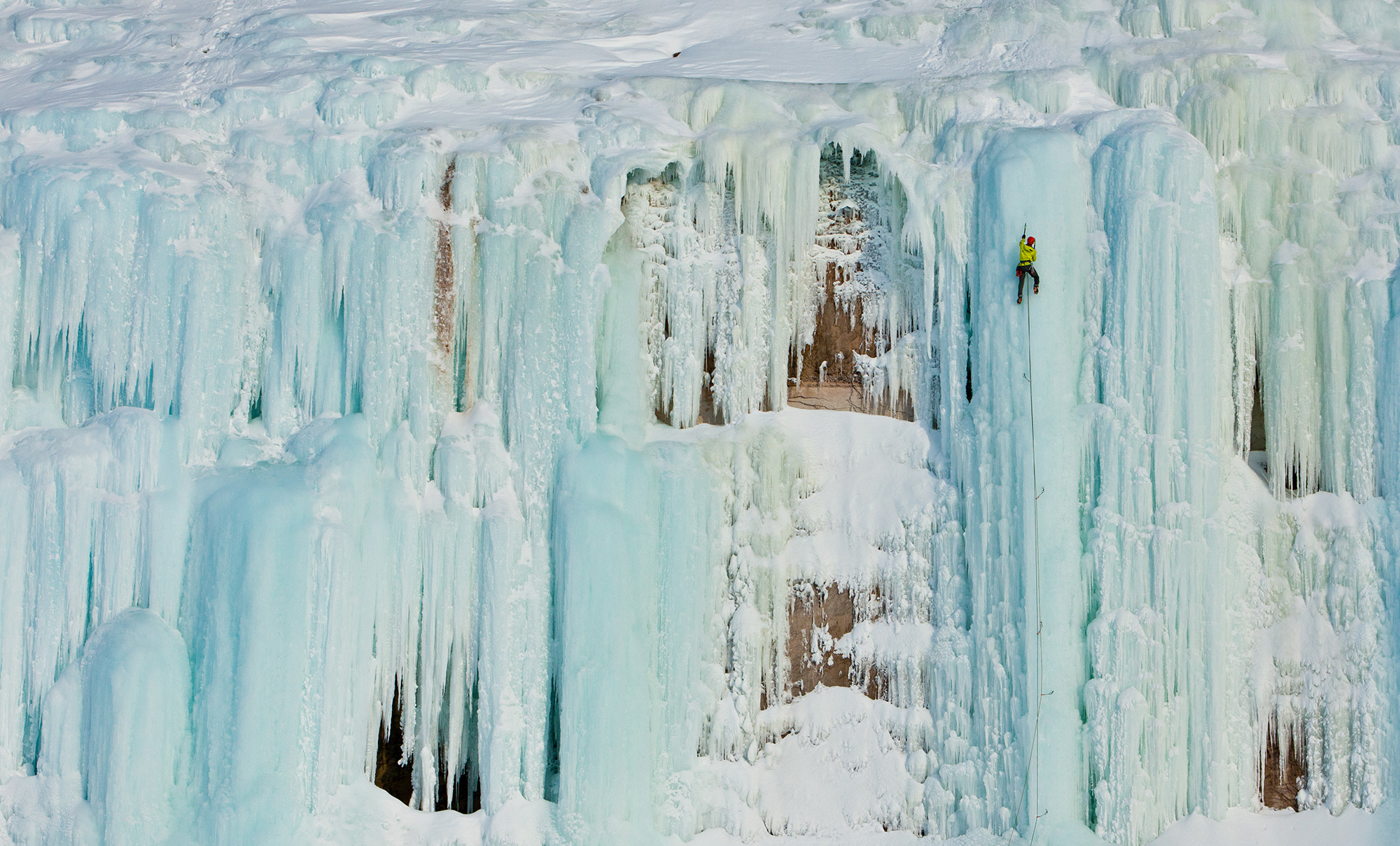 Adam Dailey takes his pick of aesthetic blue ice lines along the western shore of Grand Island, Michigan