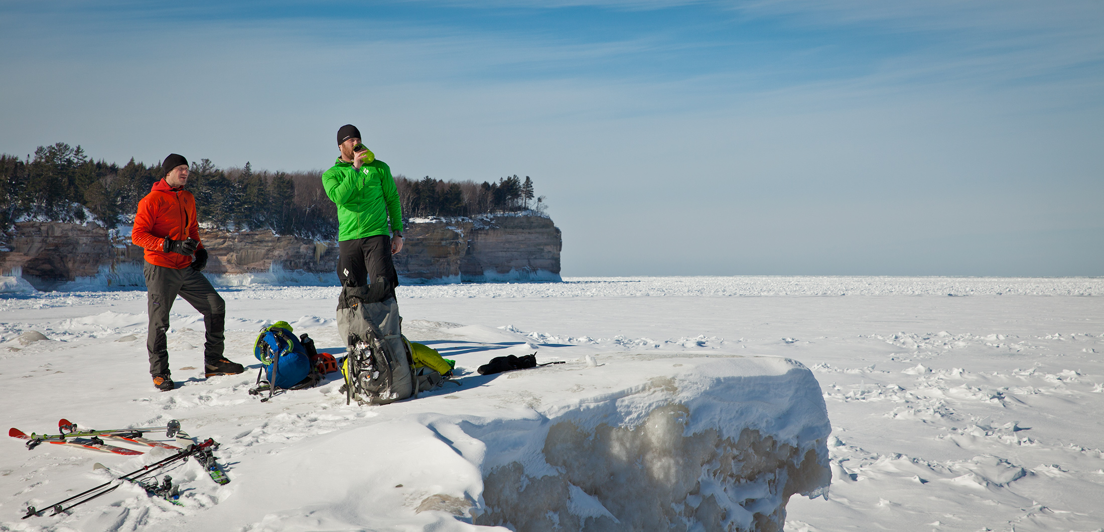 Adam Dailey and Jon Jugenheimer take a rest at Chapel Beach after skiing several miles through the woods of Pictured Rocks National Lakeshore.
