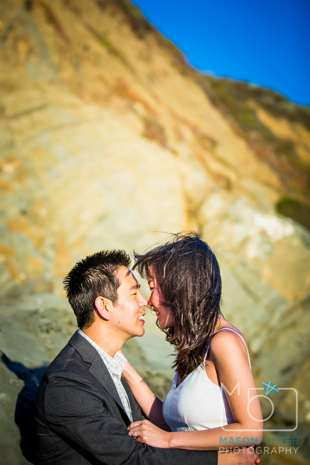couple in the rocks at baker beach, san francisco - engagement photography
