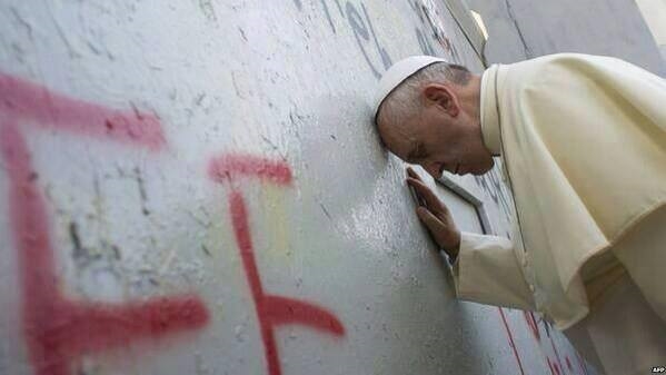 Pope Francis praying at the Separation Wall in Bethlehem