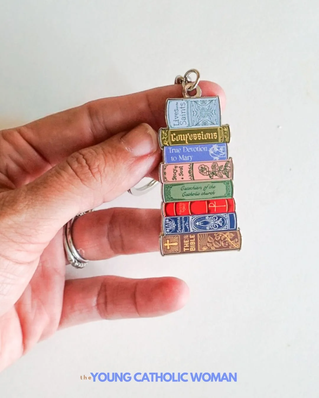 We were so excited to learn that @brickhouseinthecity began offering wholesale! Now we get the privilege of carrying some of their gorgeous products, such as this sweet Catholic Library Book Stack Keychain! 📚