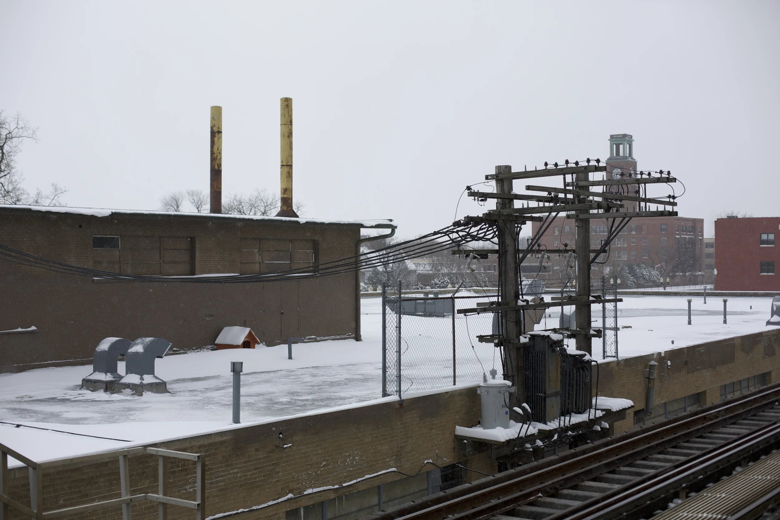 This rooftop is home to a dog on warmer days, but his hut is almost buried by the snow. I hope he's warm and inside.