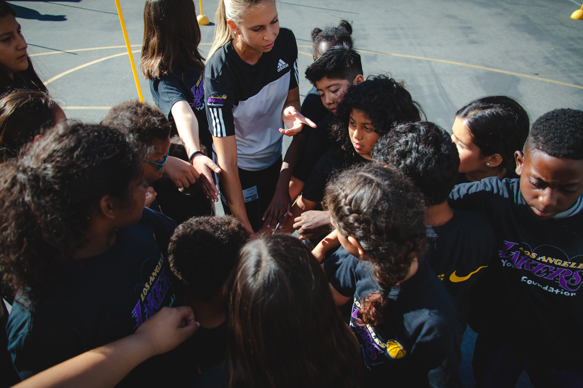Coach bringing in the kids of the Santa Monica Boys & Girls Club during the Lakers Health & Fitness Camp.