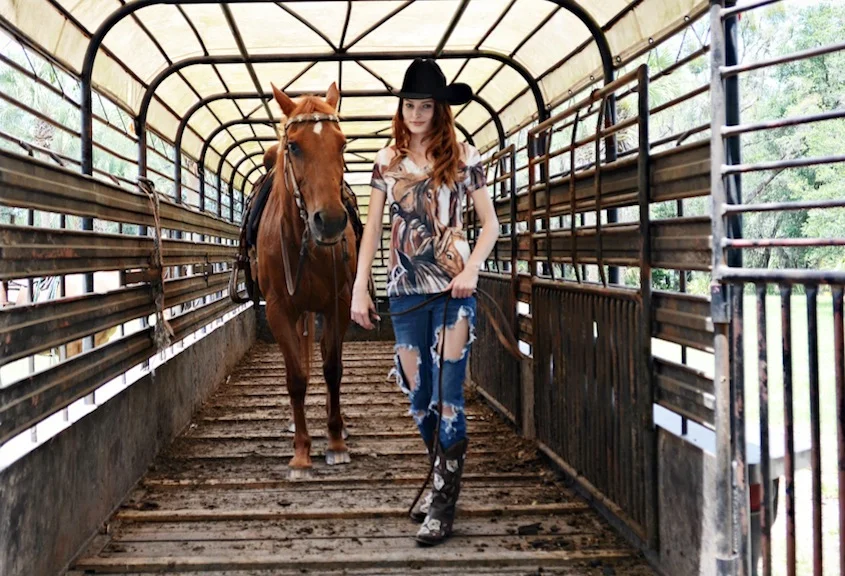 Cowgirl with horse inside truck Jane Shirek.jpg