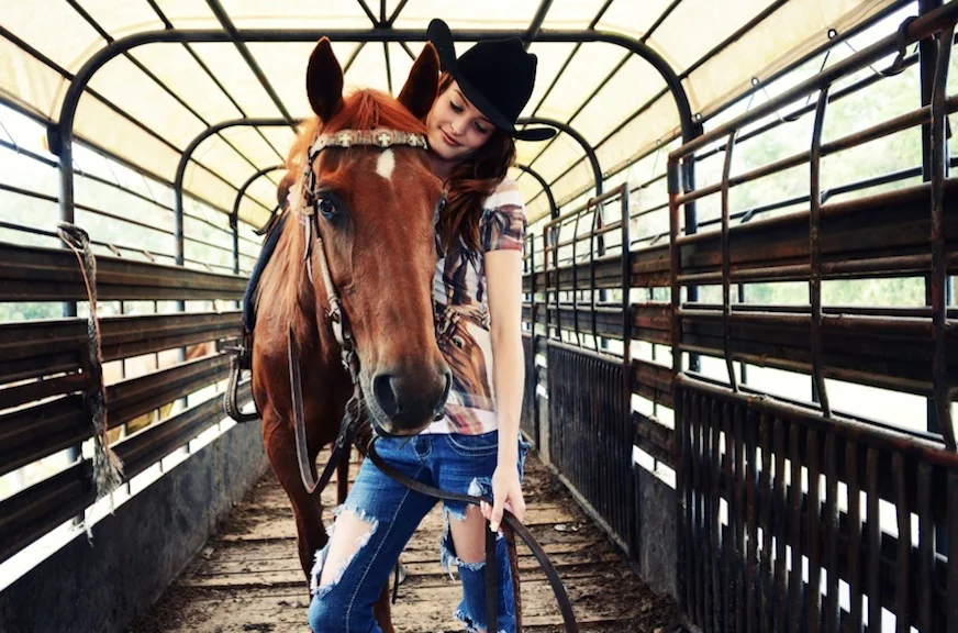 Cowgirl looks lovingly at horse Jane Shirek.jpg