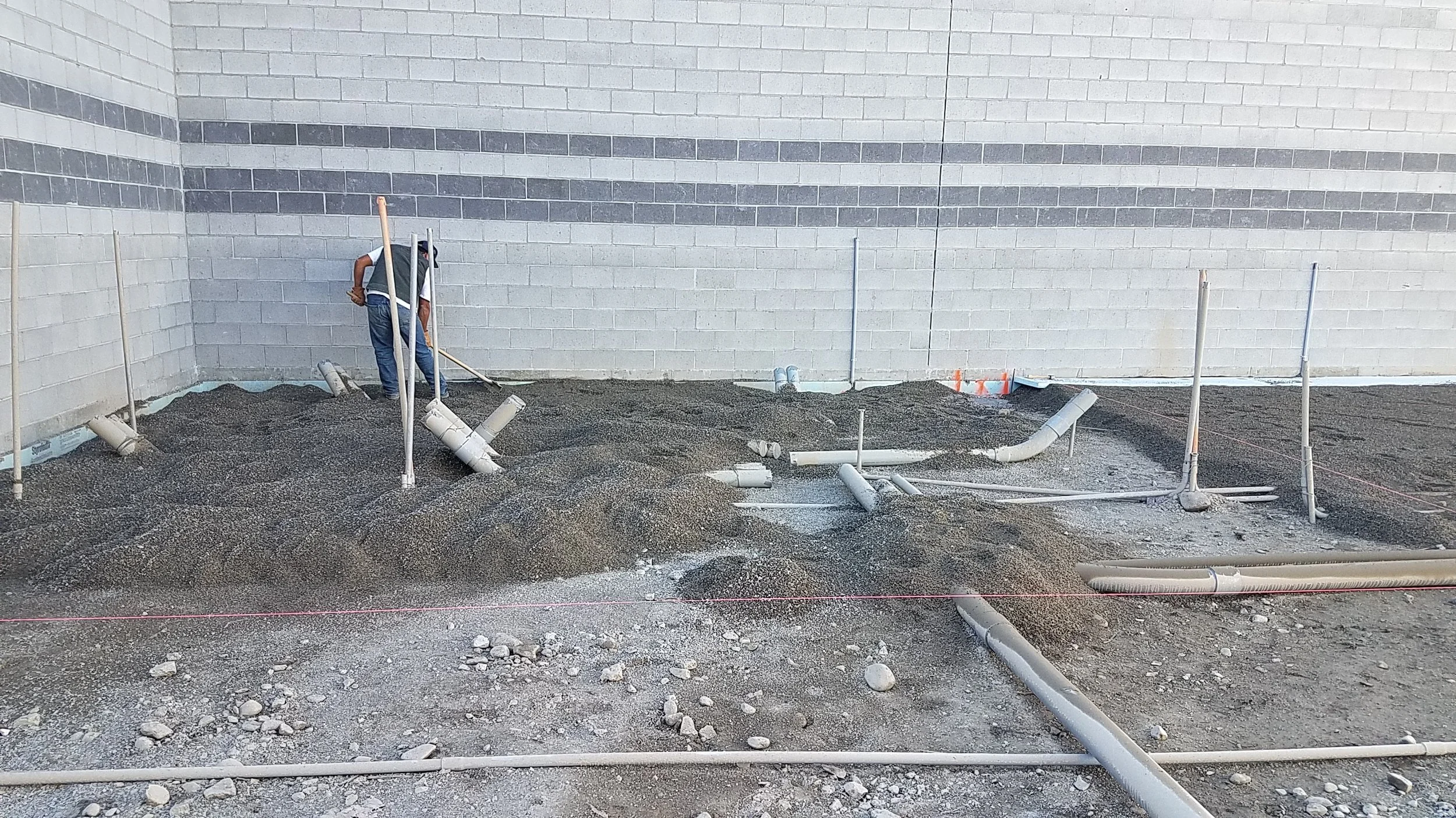 They raked the gravel out and made sure it got everywhere evenly, using string lines to get the elevation correct.