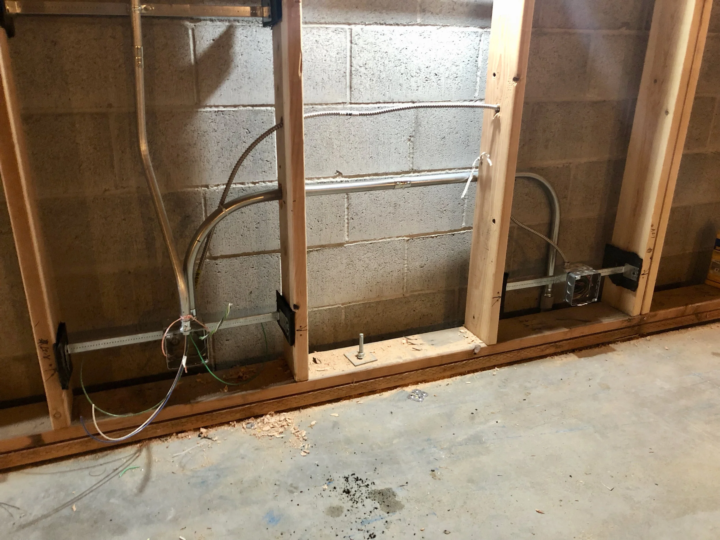 The electricians made some headway this week. There was some discussion as to how to mount the electrical boxes and keep them isolated from the framed walls but sitting in the sheetrock and other acoustic materials which will be mounted. The solution was to use some isolation material between the mounting hardware for the electrical and the framing.