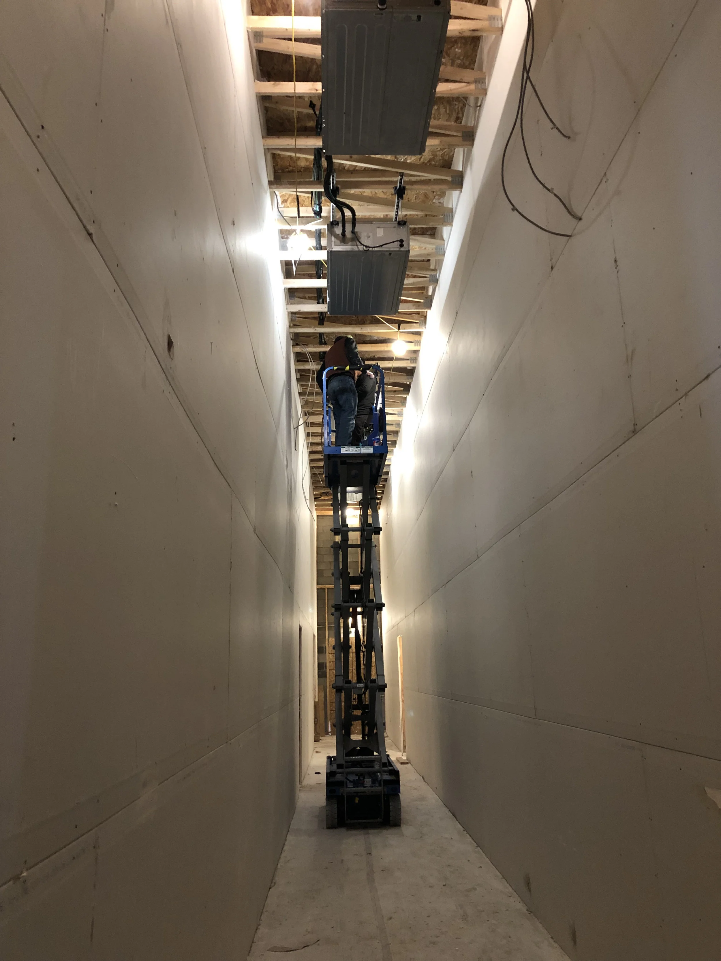 All four of the mini-split air handlers for the studio spaces are hung in the hallway now.