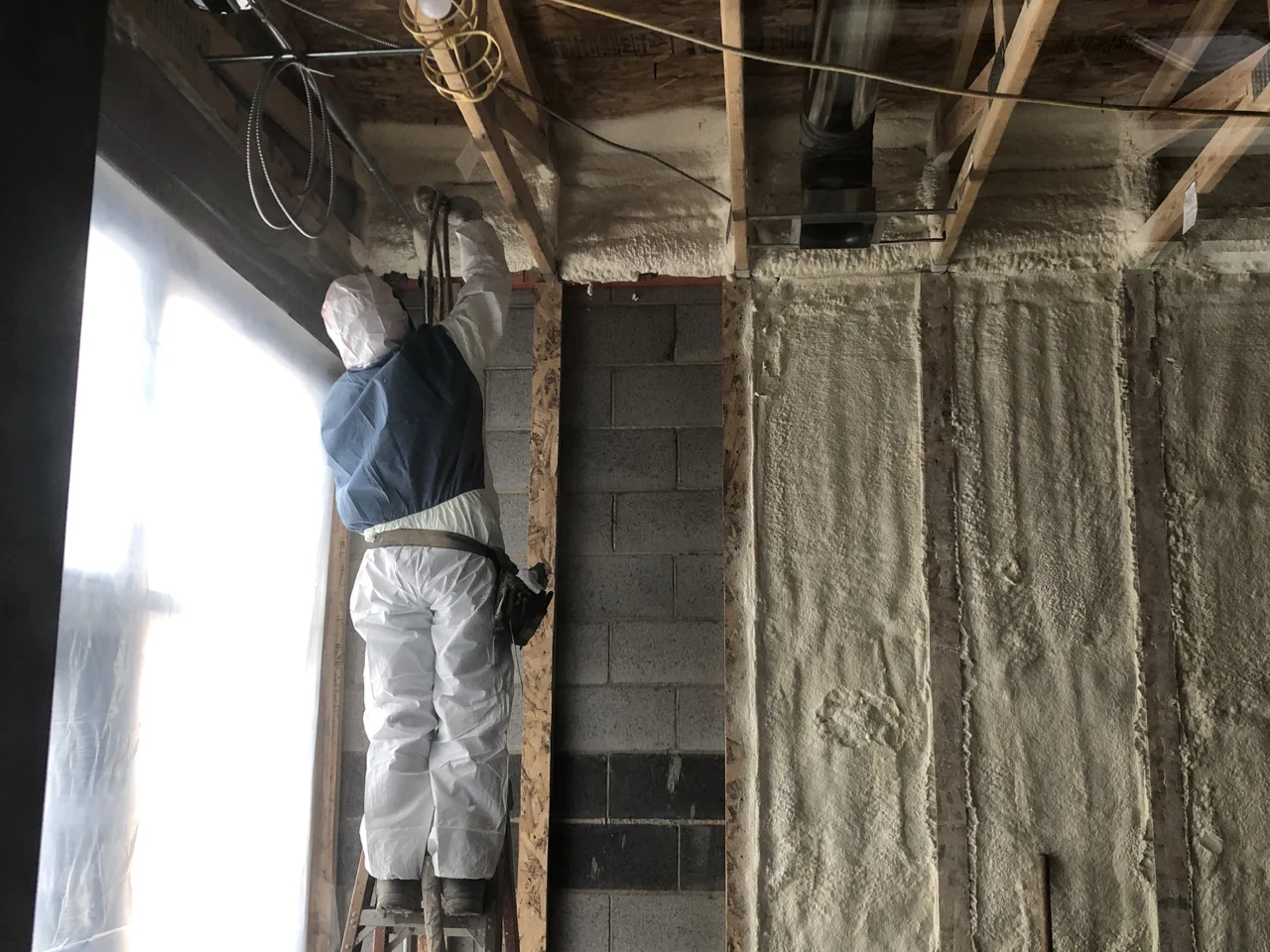Spray foam insulation in the lobby where we didn’t want to lose the space that a traditional framed wall would eat up.