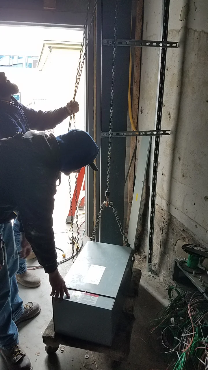 This is the transformer that will clean up the power for the studios. This box is so insanely heavy that none of us could even get a corner of it off the ground, yet it needed to be hung up to be put to use.