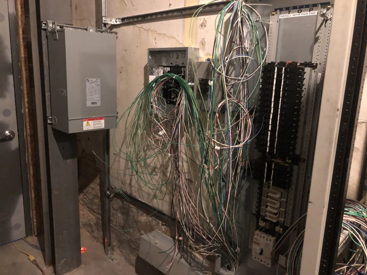 The transformer is hung on the left, in the middle is a disconnect and a surge protector, on the right is the panel for the clean power to the studios.