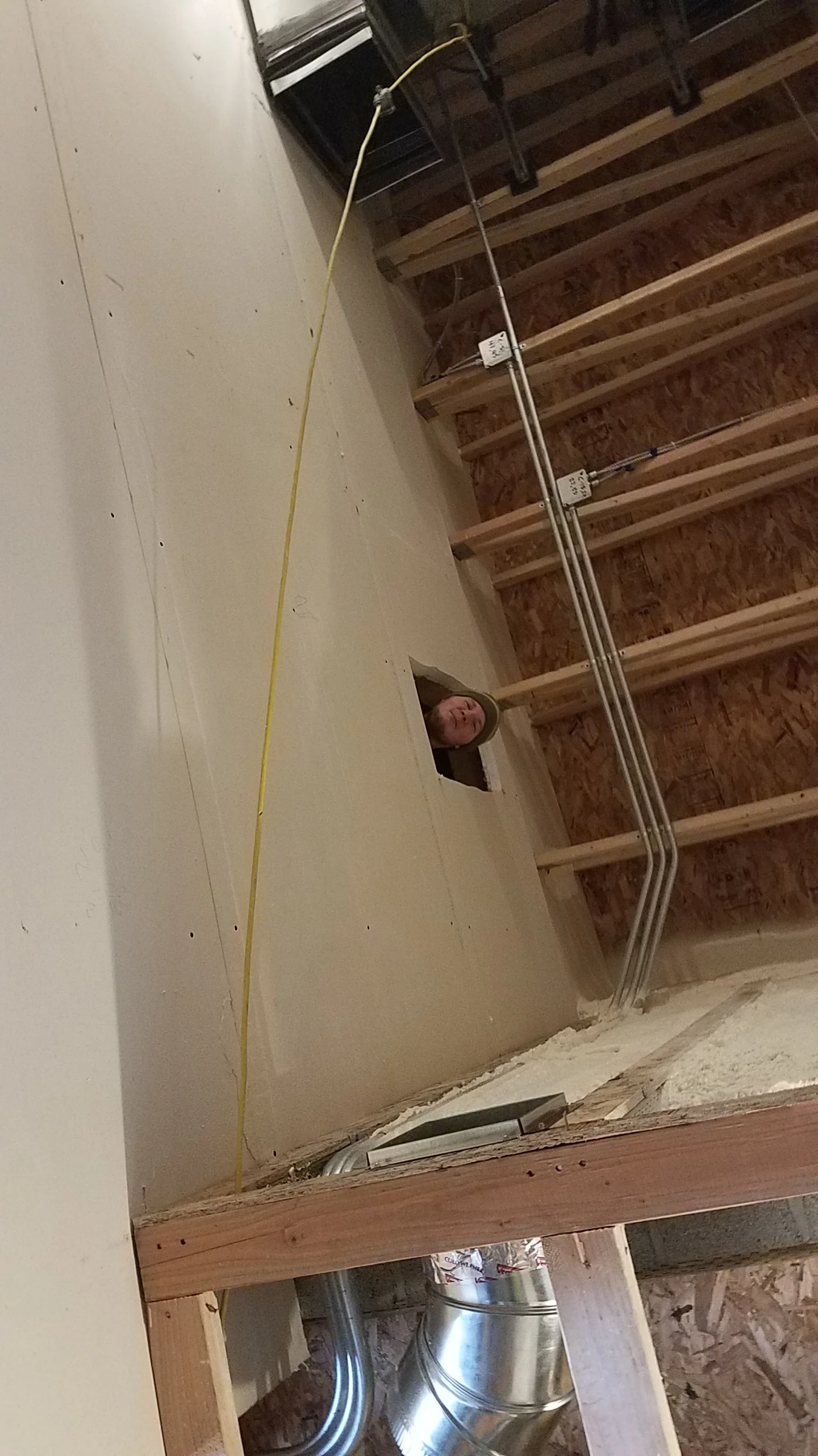 Penetrations have been cut into the studios. At the top of the frame you can see the duct with a rubber vibration isolator. This will help stop vibrations in the units from reaching the ductwork.