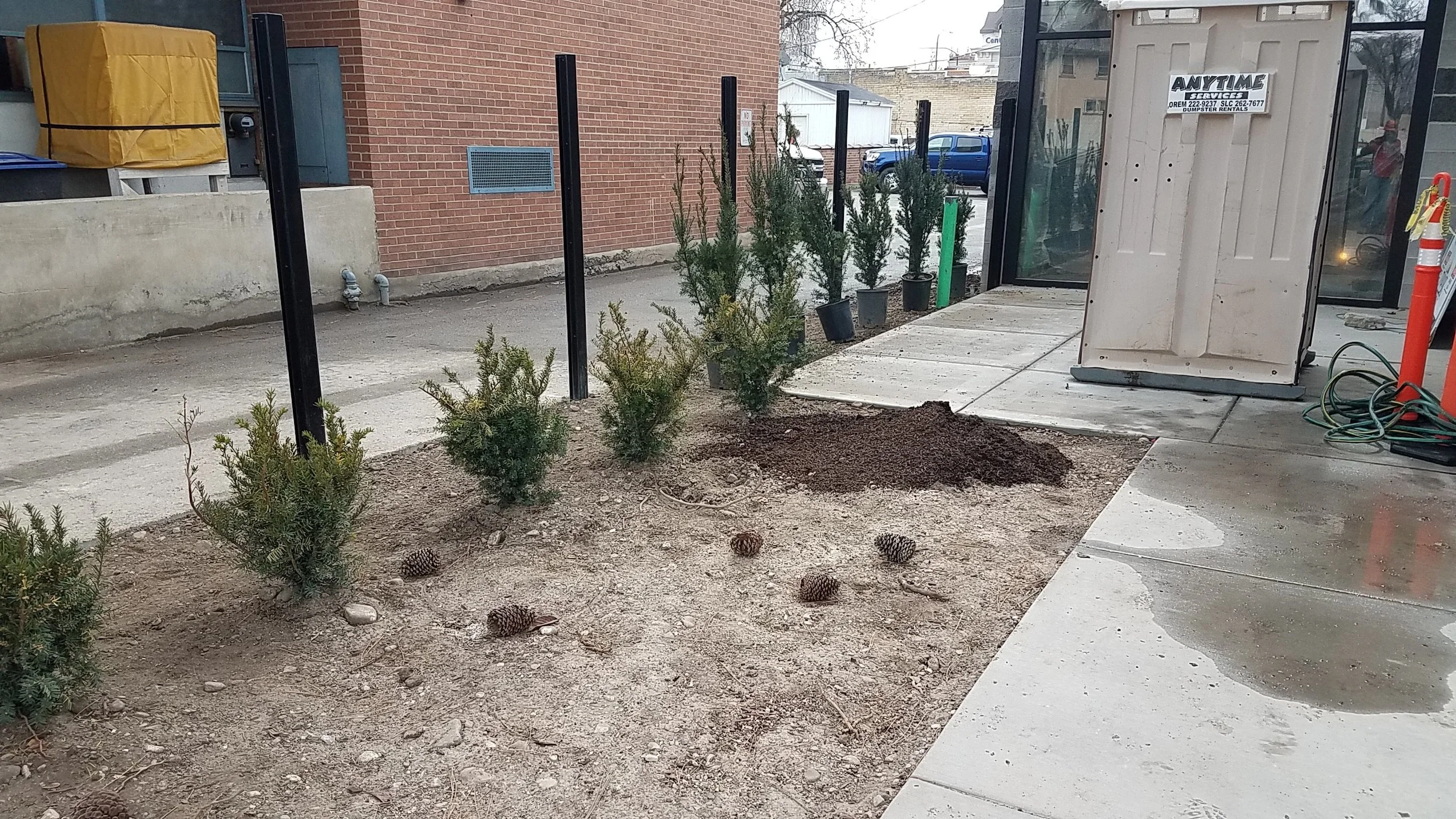 The warmer weather brought back the landscapers who managed to get just about everything other than sod done this week. Also, how I wish this outhouse was not in the middle of our new entrance.