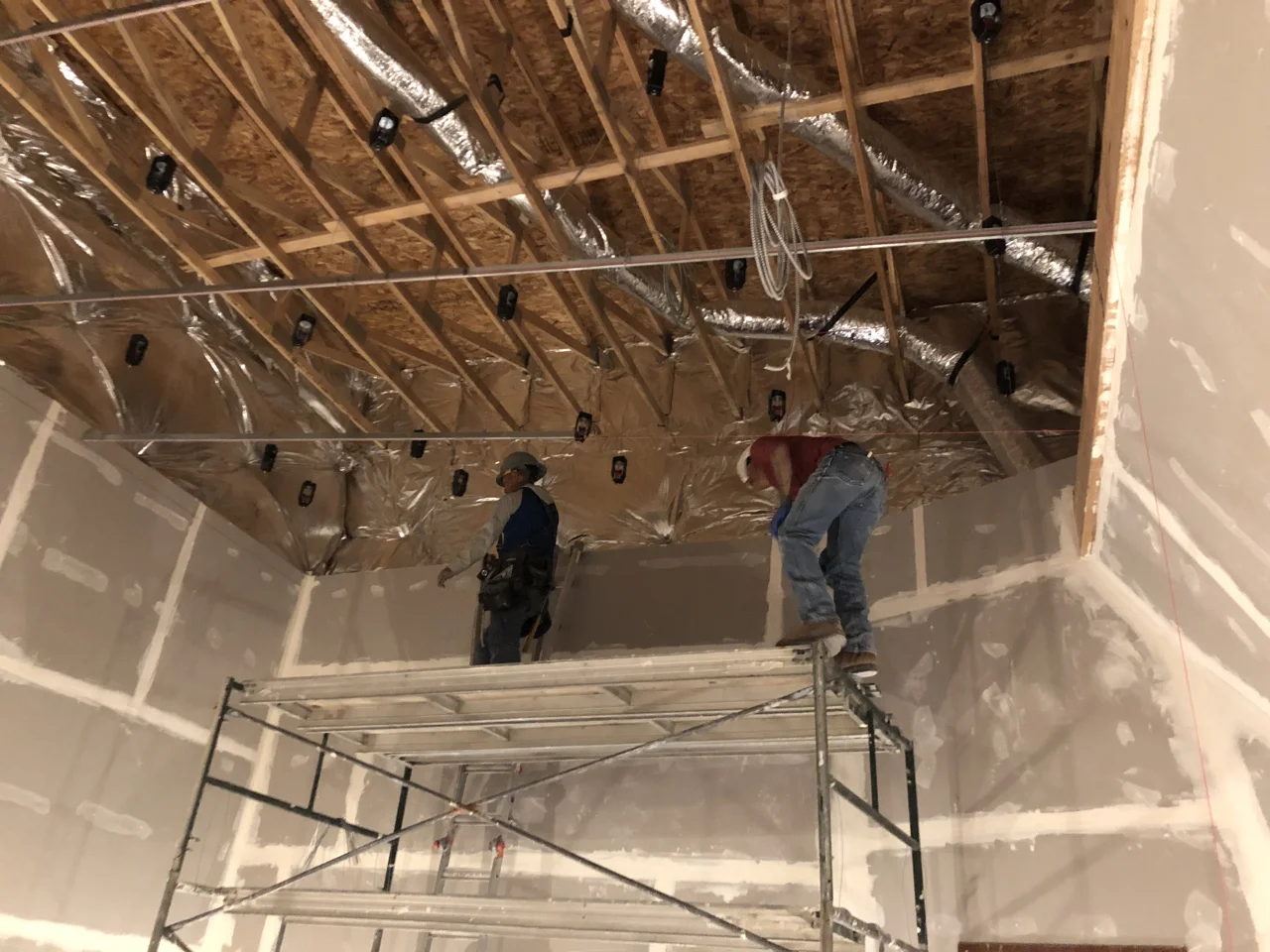 The crew started by hanging tracking room 1 as it was a rectangle and level, now they are moving on to control room 1 which is a sloped ceiling and not quite so full of right angles.