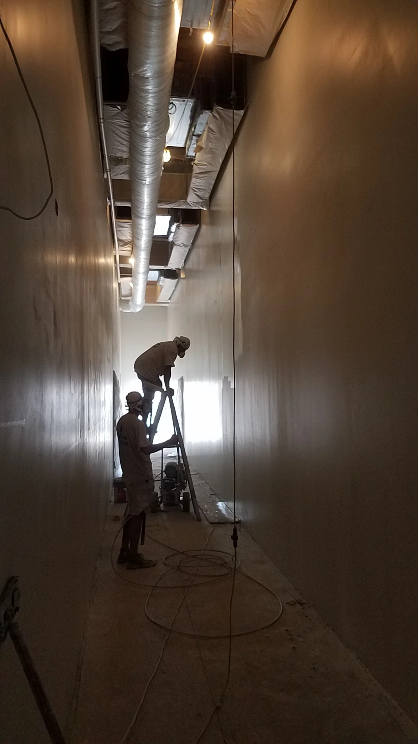 It turns out that we didn’t really end up with the greatest drywall crew when the hallway down the middle of the building was done. The painters did what they could by painting 5-6 coats and trying to even things out, but our contractor is still very dissatisfied with the way its turned out and at this point there is a plan to have the drywall contractor come back, re-skim the entire hallway, sand it all and then paint it again. Honestly Im not sure I really care, but of course if it could be better and doesn’t cost more I suppose we should do it, but I’M REALLY SICK OF DRYWALL DUST!