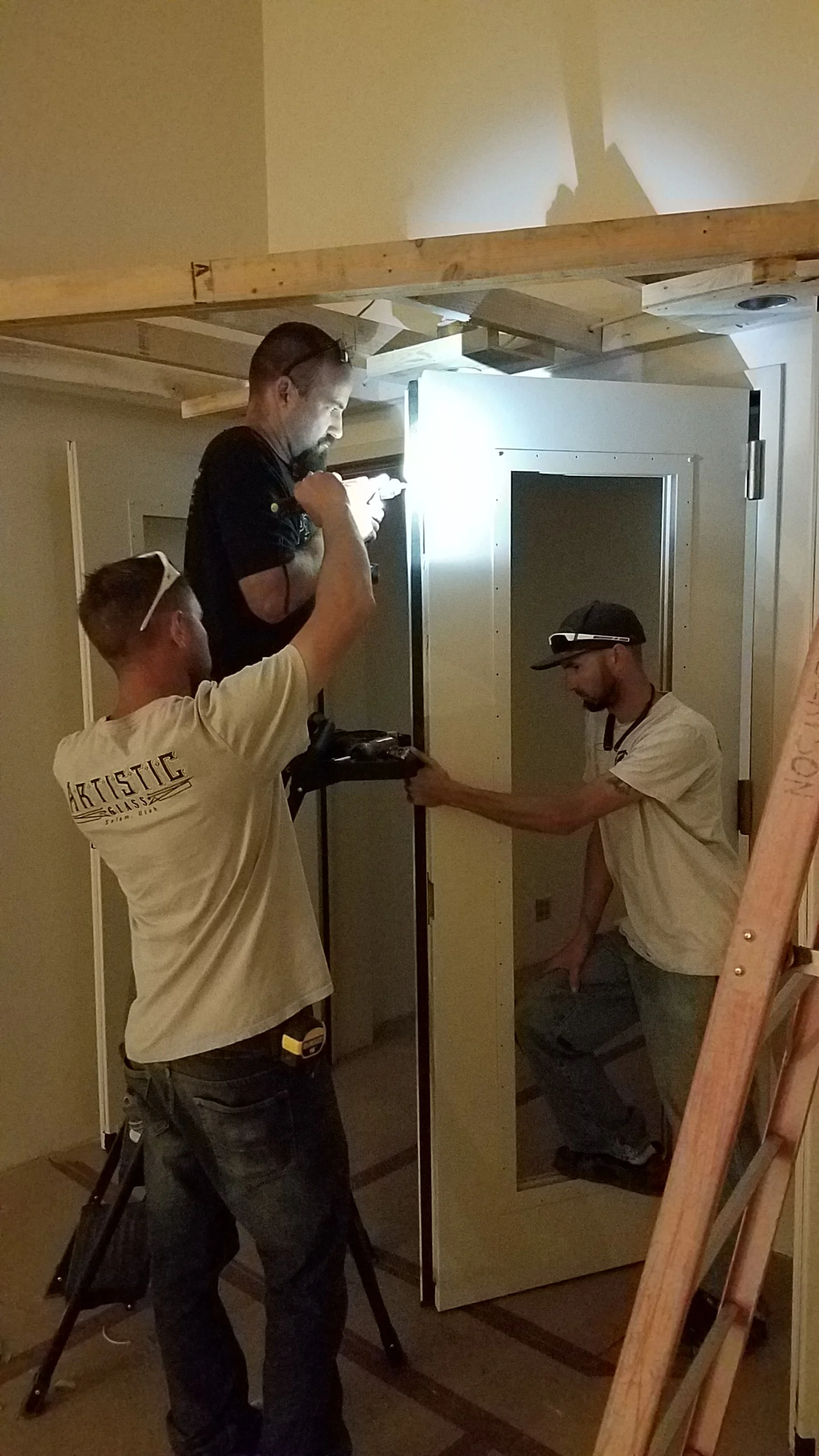 Installing the seals and the bolts to hold the “inactive” door closed.