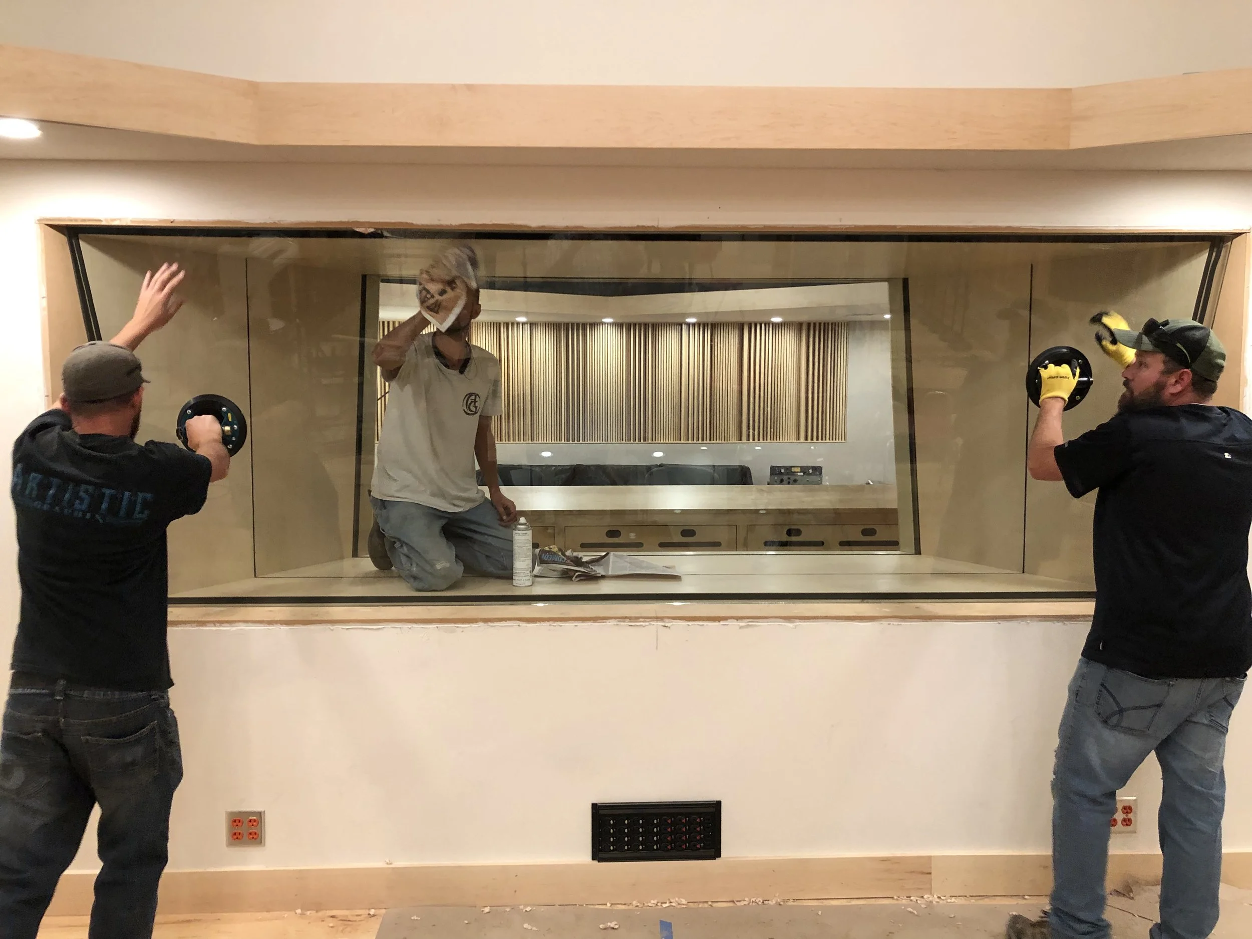 Final cleaning of the glass for the tracking room of studio 1.