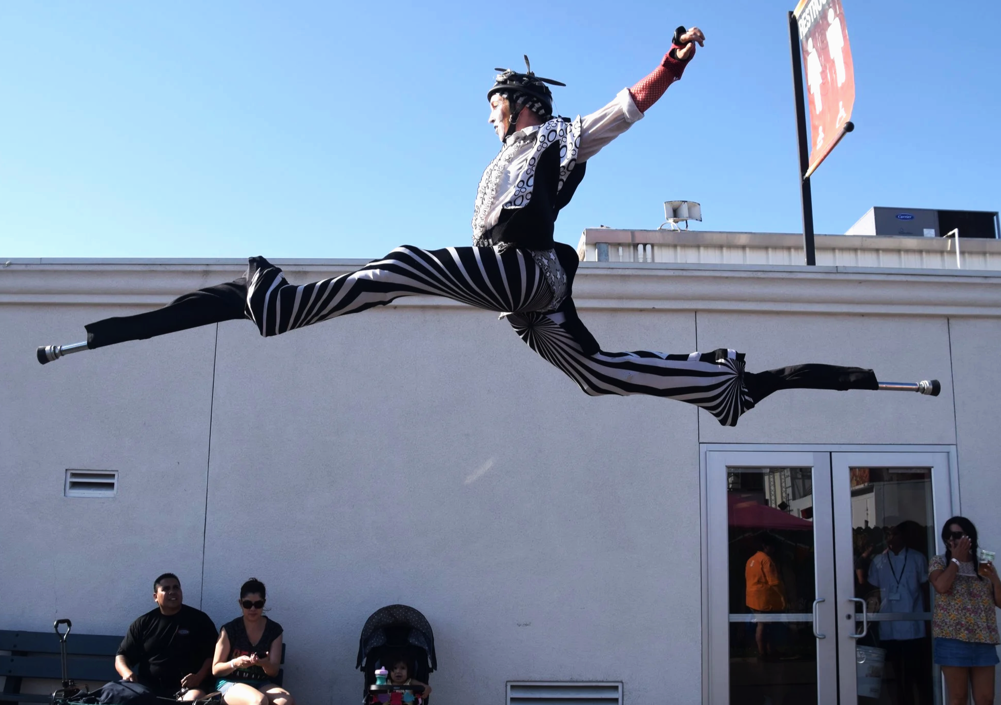 High-level acrobatic stilt performance by STILTSHOW