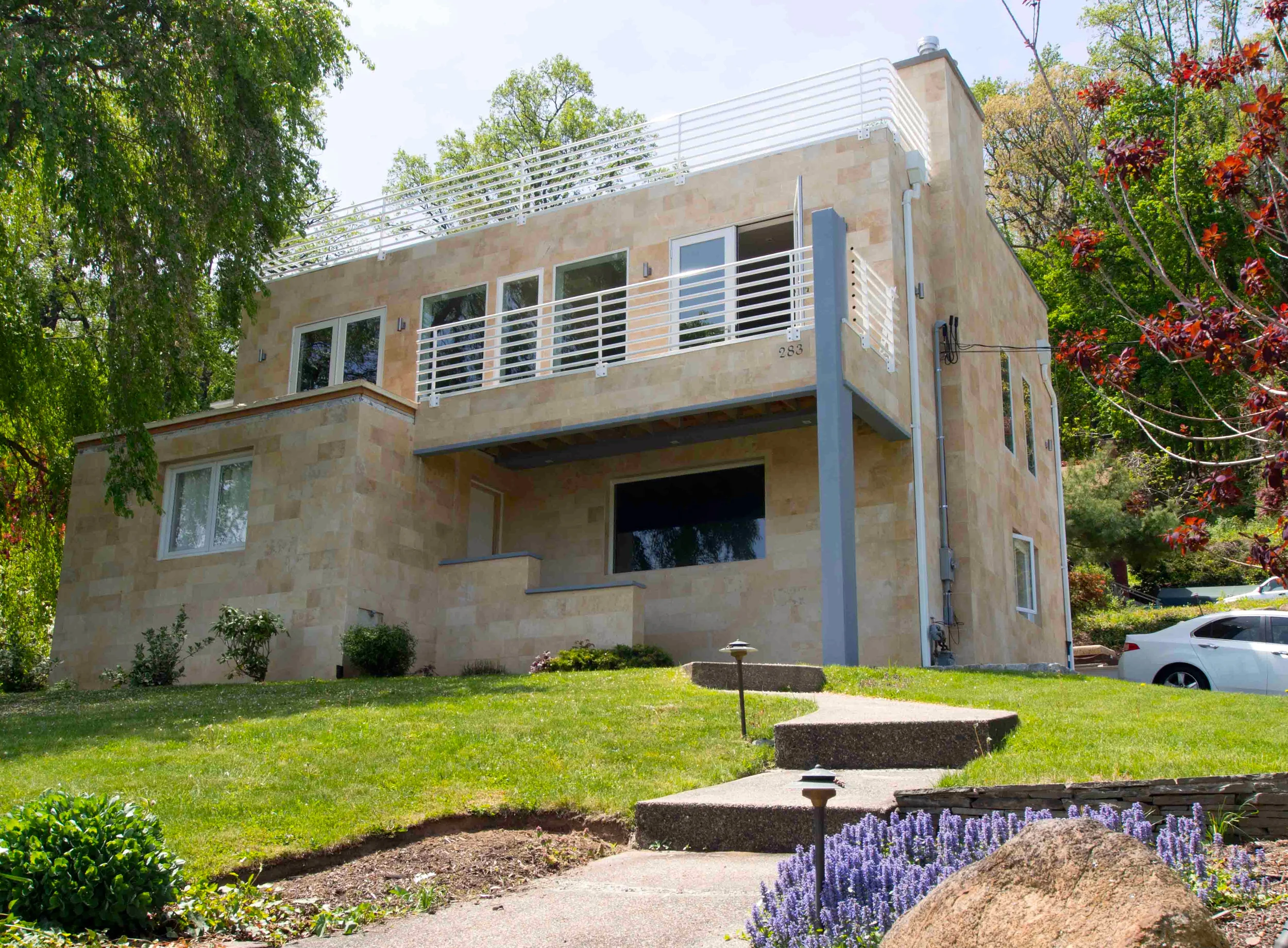 A modern twist to an existing mundane brick cape built in 1949, proved to be both a structural and architectural challenge.