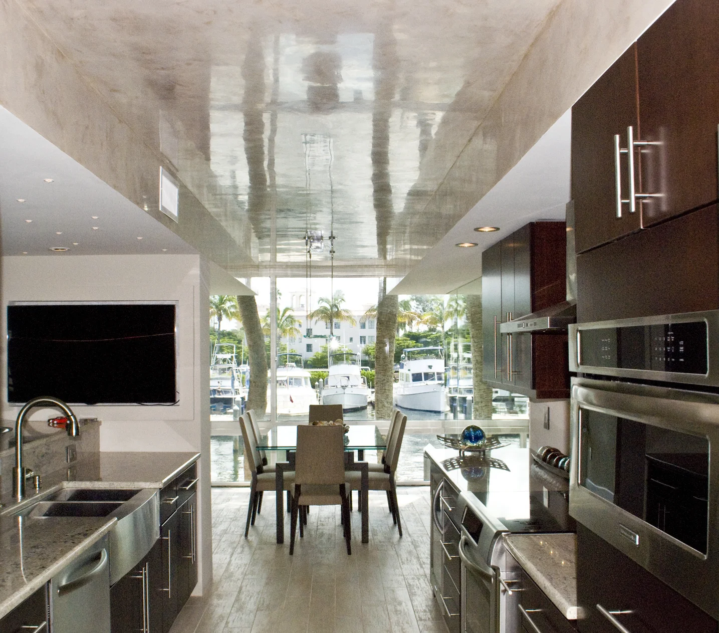 A slick Venetian Plaster ceiling reflects the water for this marina suite with a renovated kitchen and dining room.