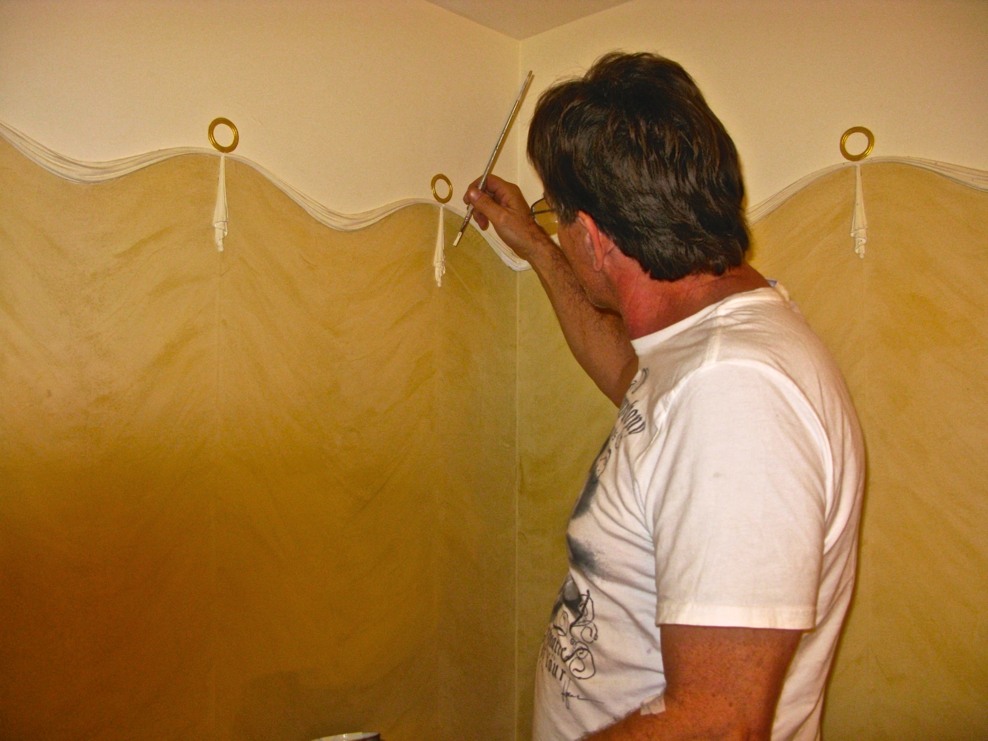 Jonathan Pettus completing a neo-classical Venetian Plaster and ornament design in a private residence.