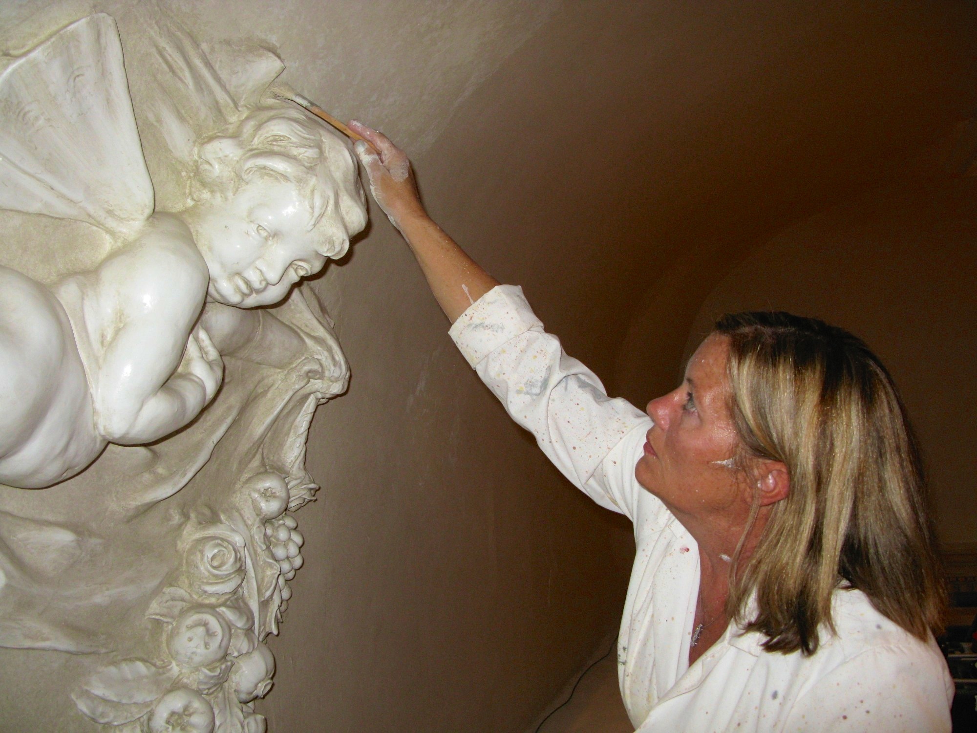 Alene Pettus restoring the decorative paint at The John and Mable Ringling Museum of Art.