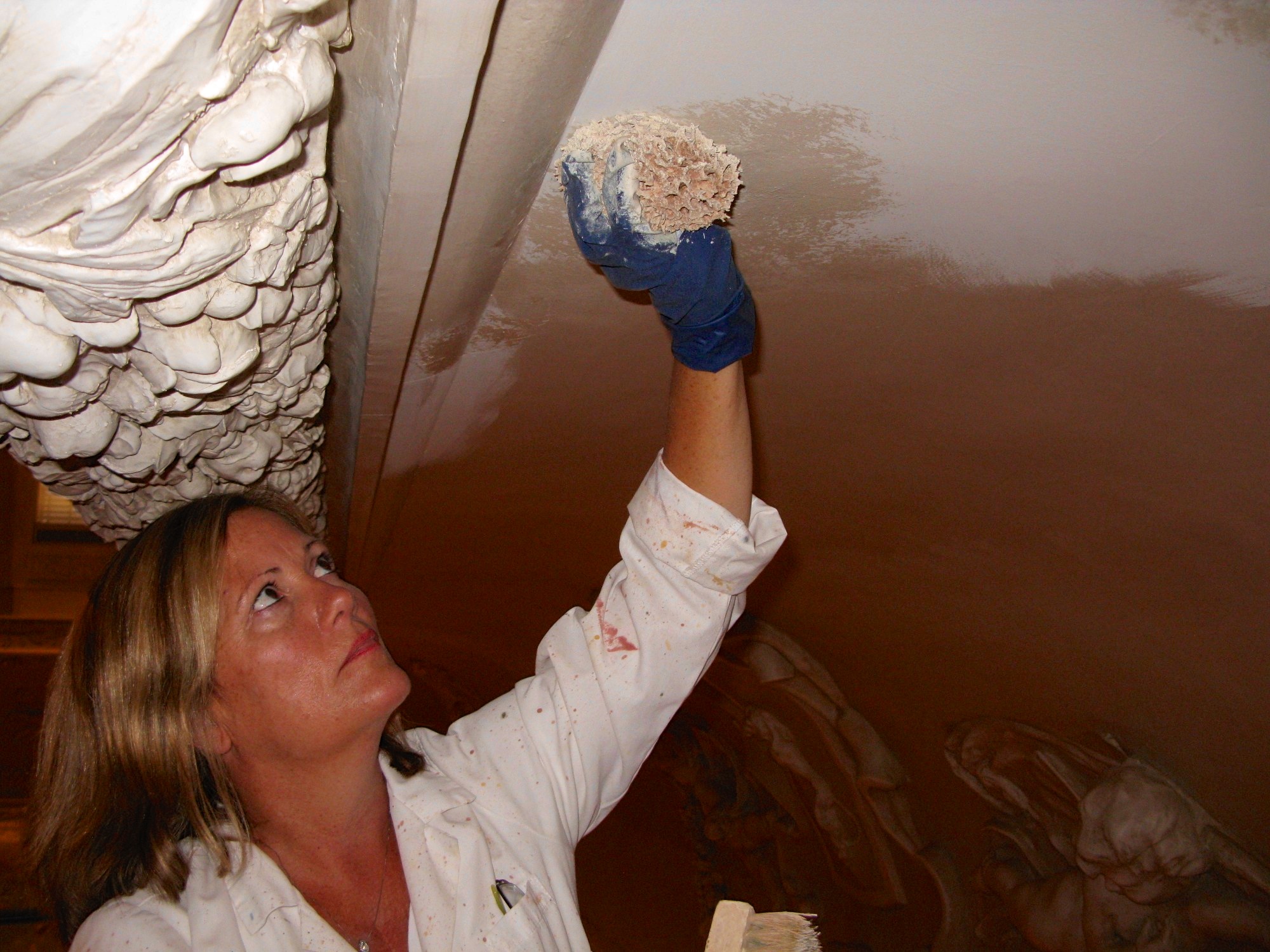 Alene Pettus restoring the cornice of The Rubens Gallery at the Ringling.