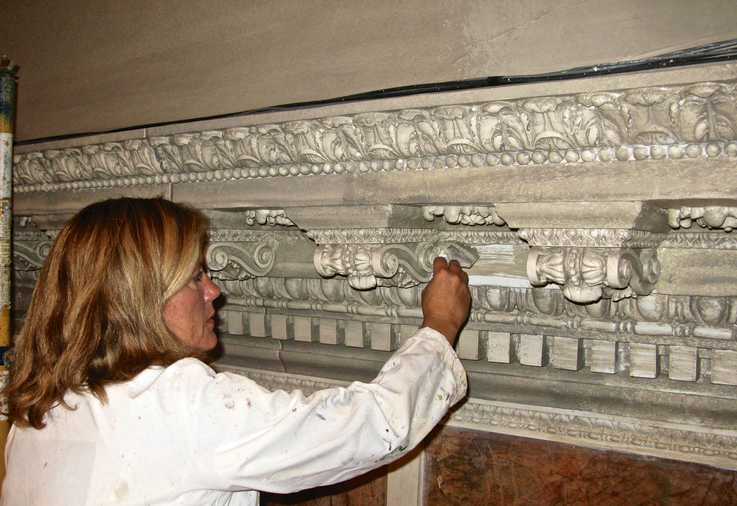 Alene Pettus restoring faux marble at the Ringling Museum of Art.