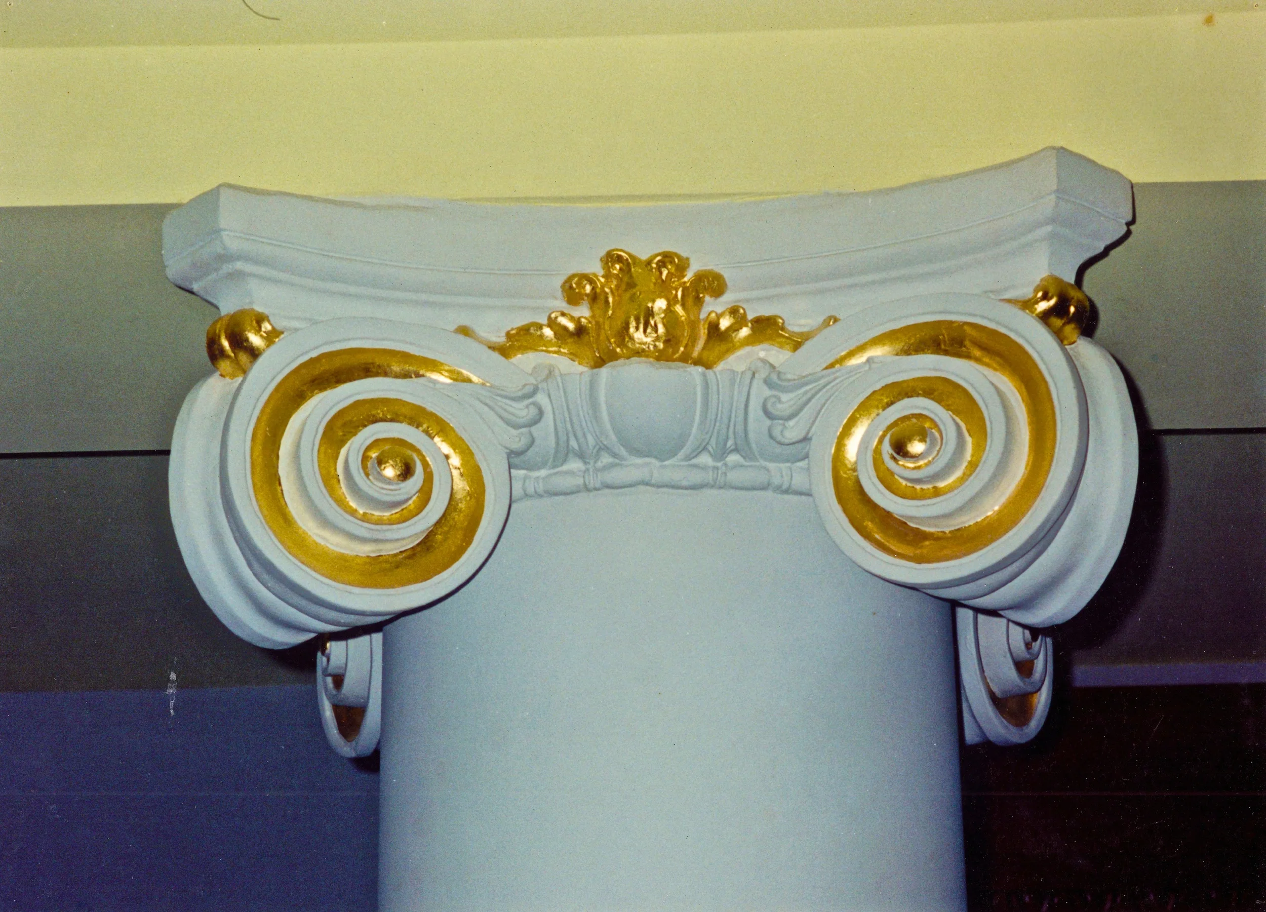 Installed plaster column with Ionic capital water gilded in 24k gold leaf.