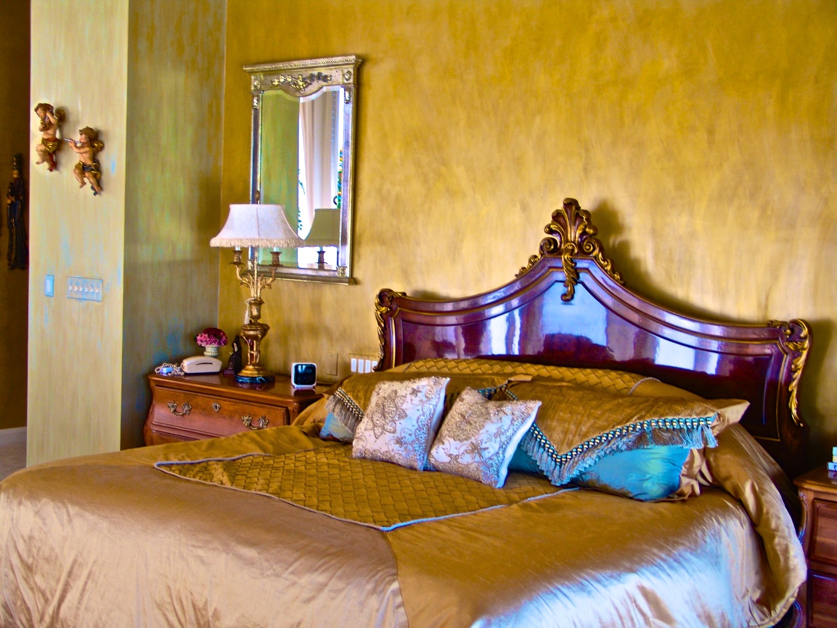 Venetian Plaster is applied to the walls in two tones to create a moire fabric effect in this master bedroom.