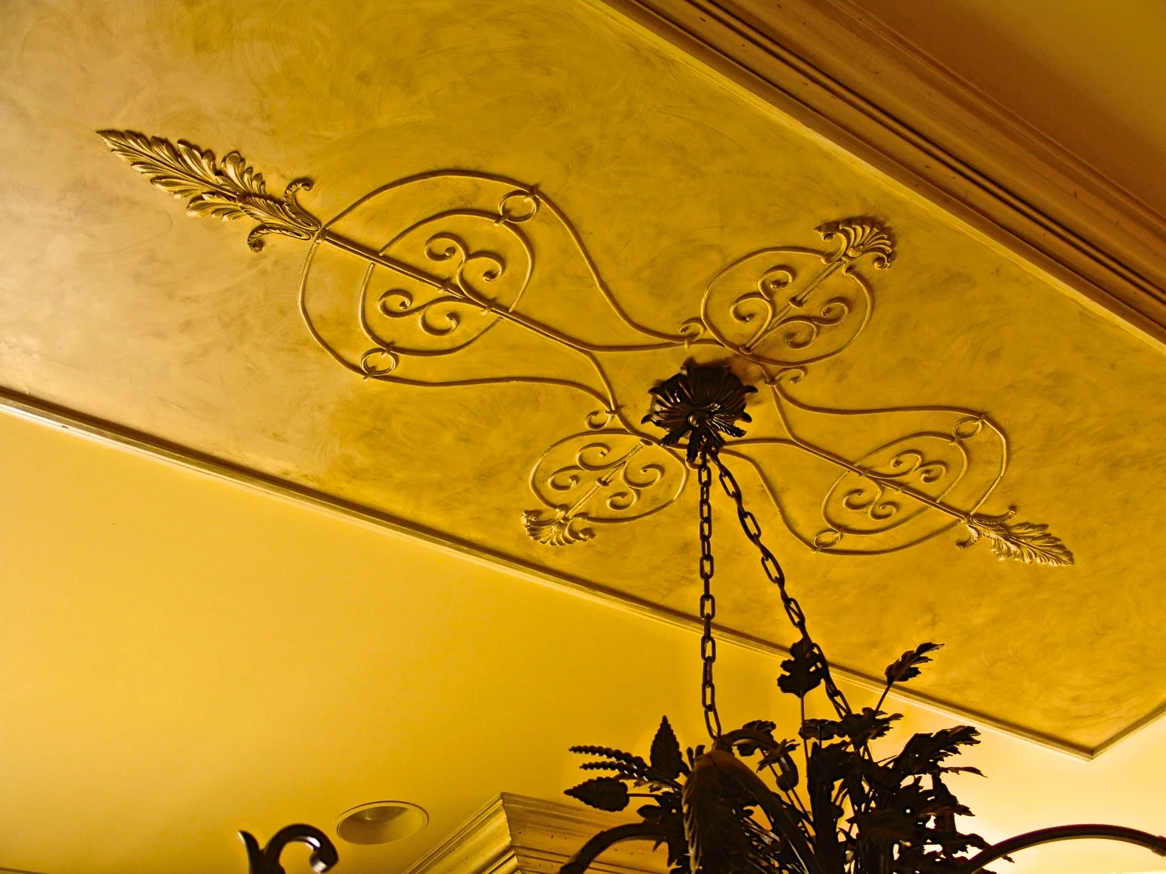 Venetian Plaster with applied ornament enhance this classic kitchen.