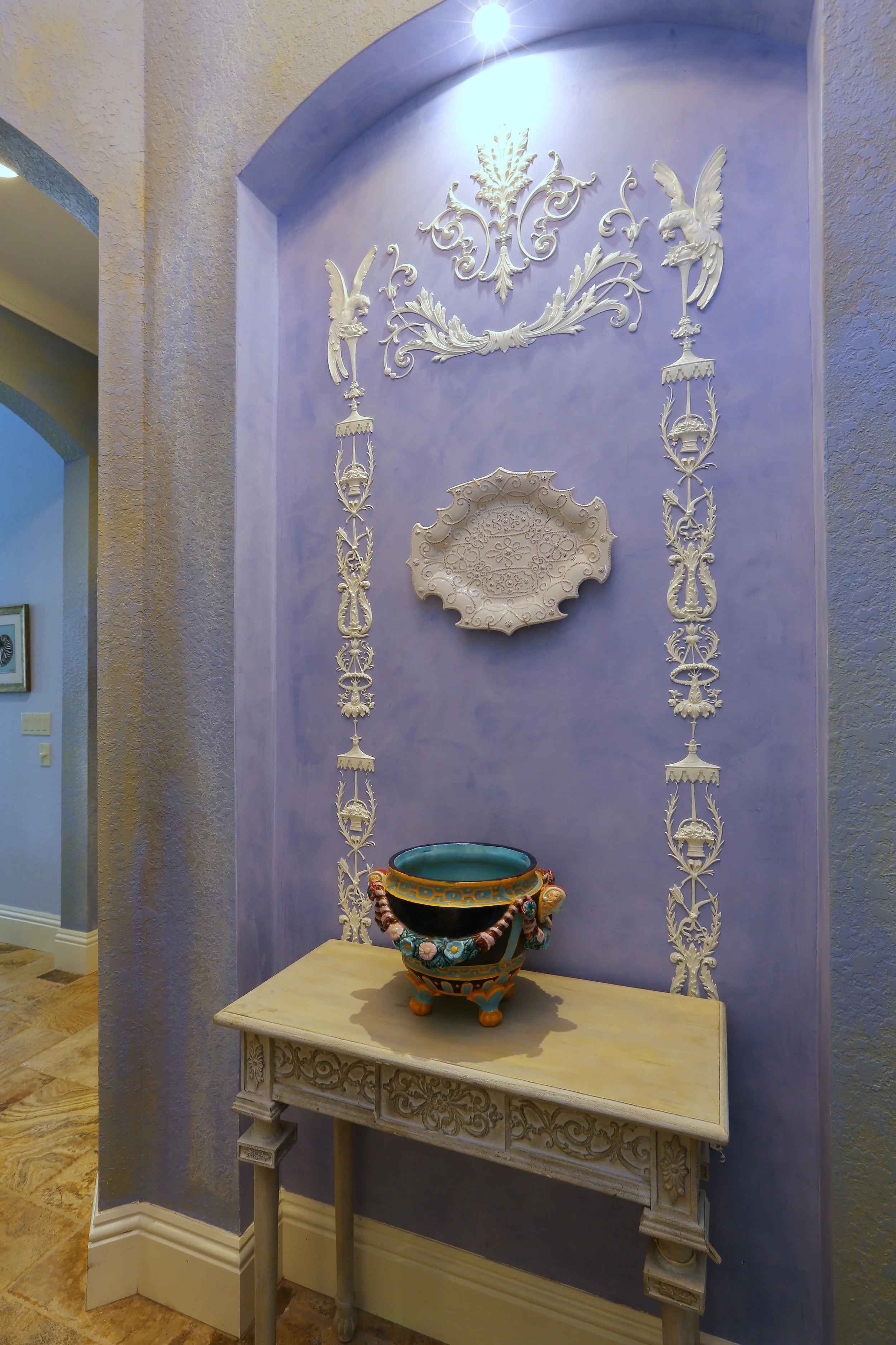 Niche done in blue Venetian Plaster with applied ornament in a classic Wedgewood design.