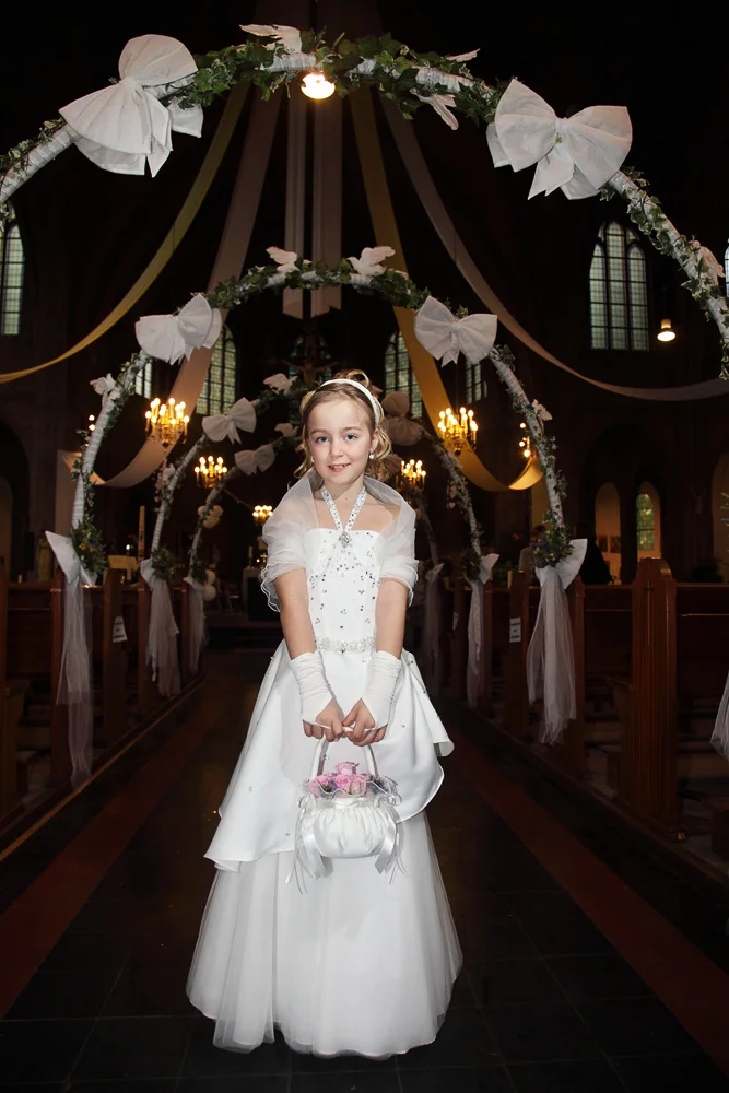 first communion girl in church aisle