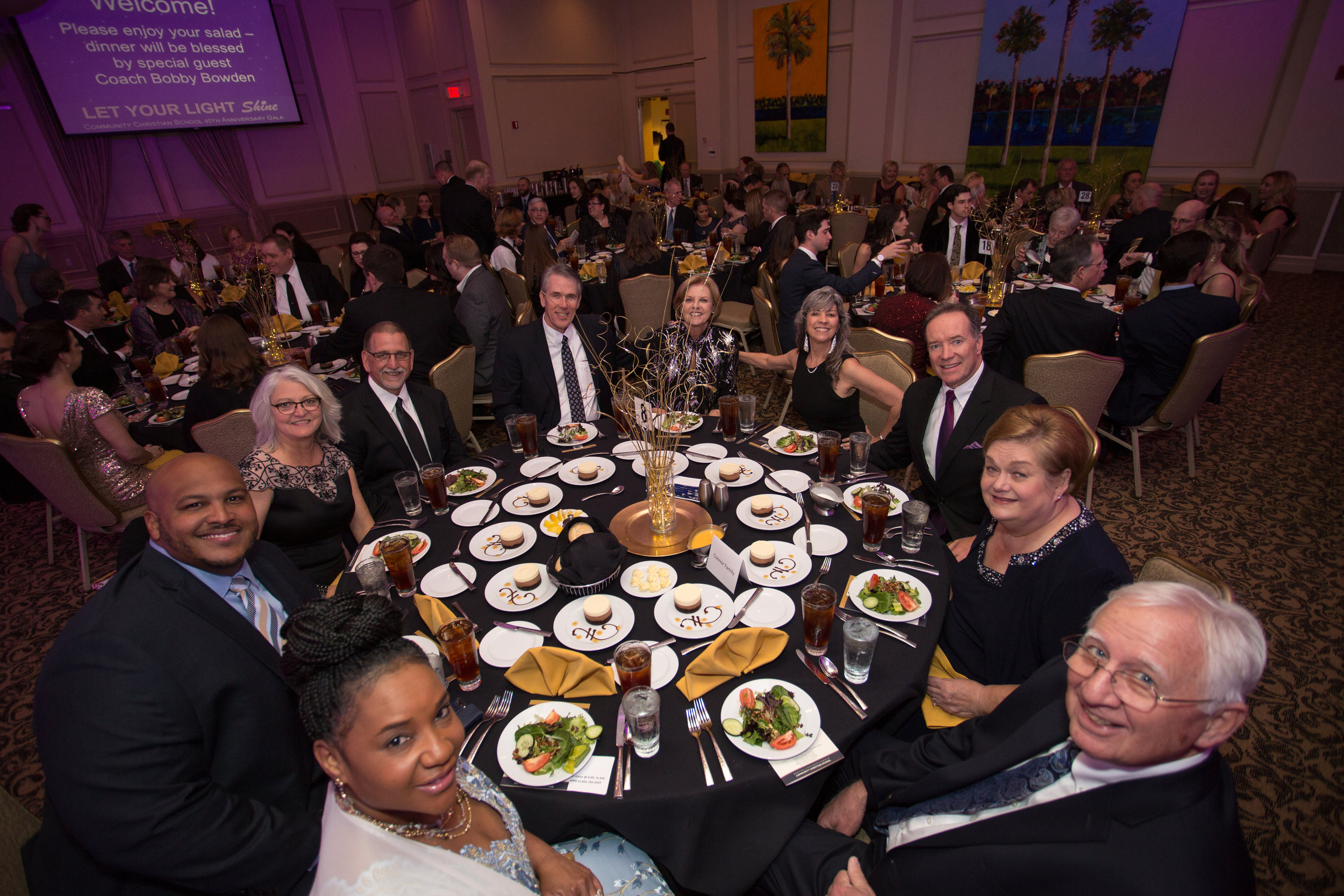   Celebrity guests Mr. and Mrs. Corey Simon entertain their table after Coach Bowden blesses the meal  