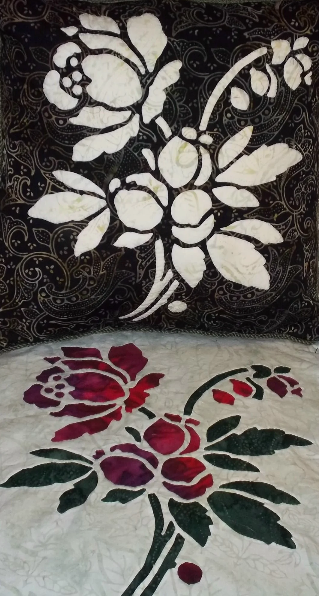 Rose pattern in batiks. top picture: 16" x 16" pillow with reverse needle turn applique. bottom picture: 16" x 16" block employing appliqued blossoms on a top of reverse appliqued stems and leaves. 