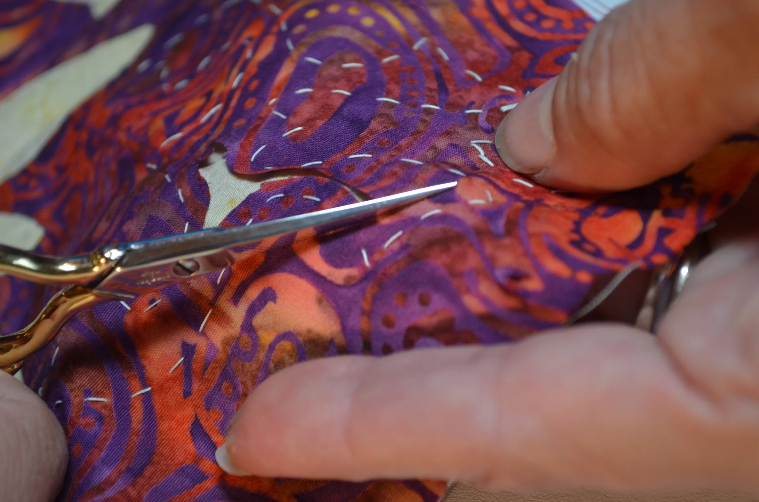 5. Creating my seam allowance, cutting with scissors parallel to the basting line, and about 1/8" - 1/4" away from it.