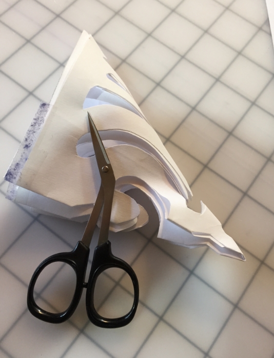 Creating design with paper and scissors.