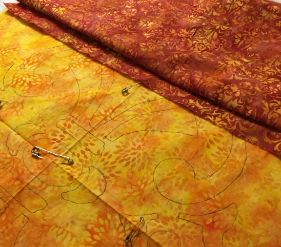 Background fabric, with design traced on it, pinned to top fabric. Ready for basting.