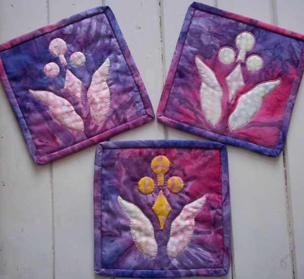 Lollipop Flower (7.5" x 7.5"). hand reverse applique(top left), machine reverse applique(top right), 3 color version(bottom)