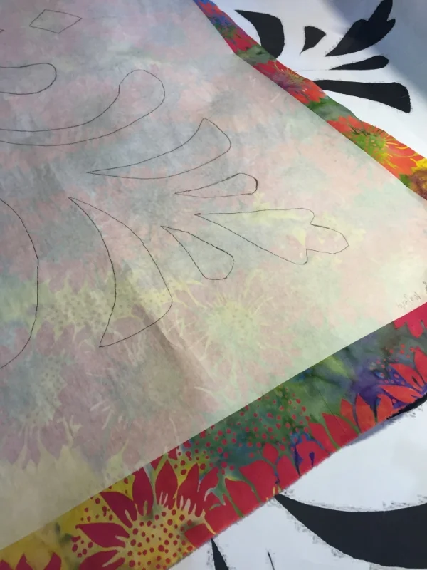 Design traced and fused onto wrong side of top fabric.