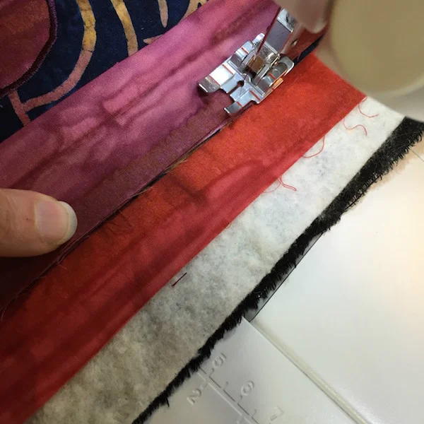 Sewing binding on with 1/4" seam allowance.