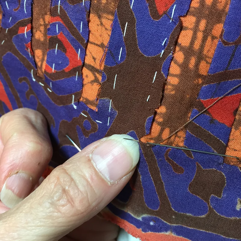 pic 3. Take a stitch into the center of the corner, catching that soft fold.
