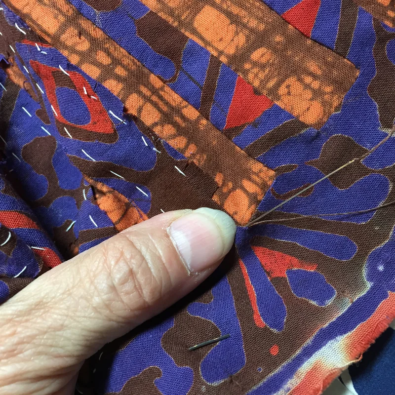 pic 4.a. With my needle, I pull deeper into the corner, taking the tip behind the fold.