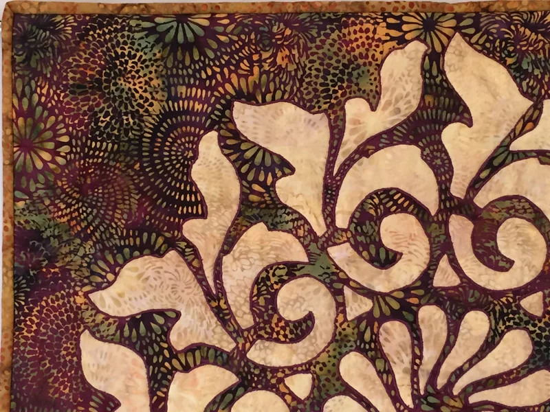 Satin stitched in Mulberry wine thread.