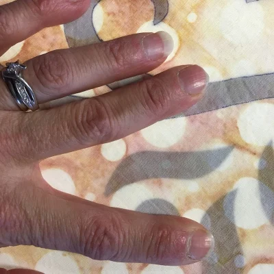 Pressing the fabric onto the pattern with my free hand. See how much more clearly you can see the pattern through the fabric?